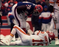 ORCHARD PARK, UNITED STATES: NY, UNITED STATES: Buffalo Bills Bruce Smith leans over Kansas City Chiefs Joe Montana (19) 23 Jan during the AFC championship game. Smith caused Montana a consussion forcing him to leave the game in the third quarter. The Bills defeated the Chiefs 30-13. (Photo credit should read DON EMMERT/AFP/Getty Images)